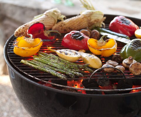 Various grilled vegetables on a barbecue.