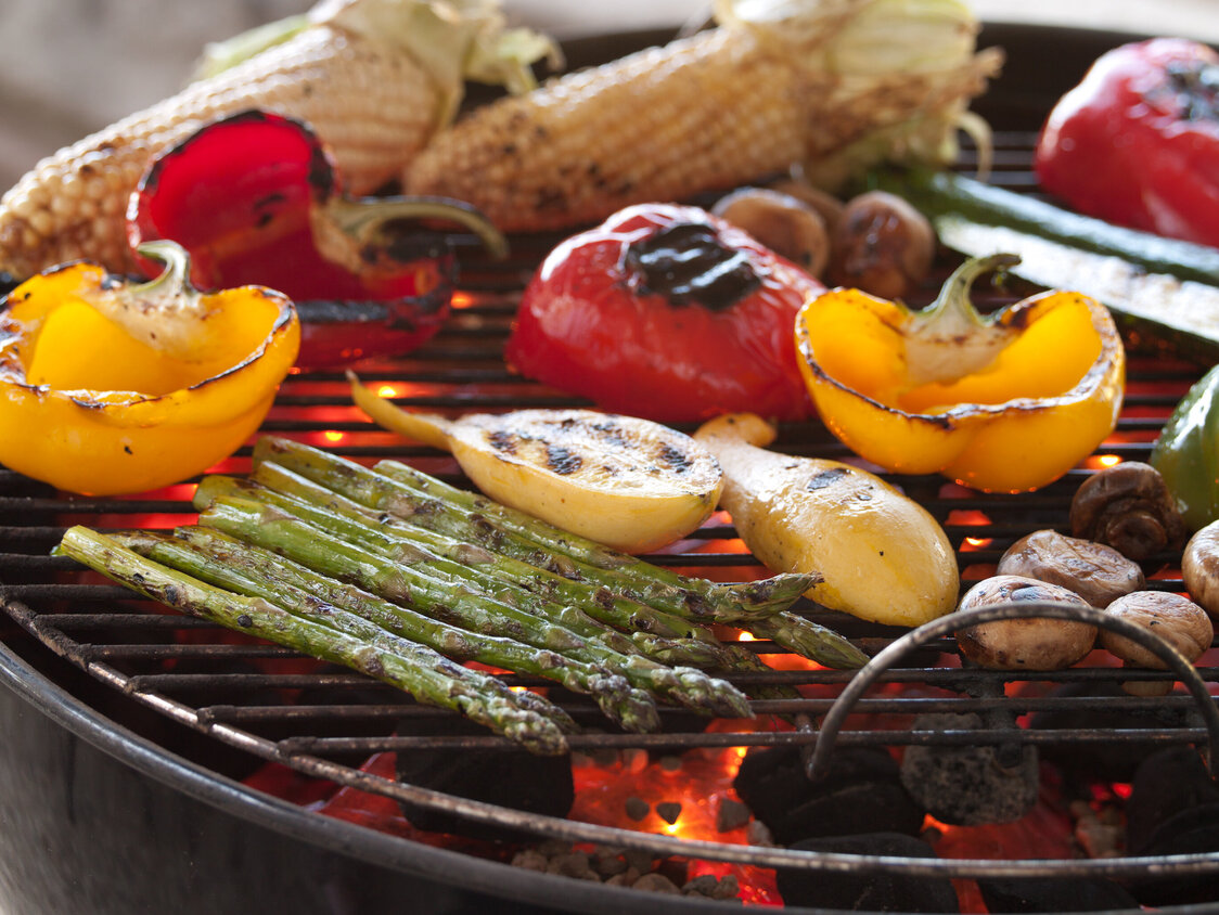 Various grilled vegetables on a barbecue.
