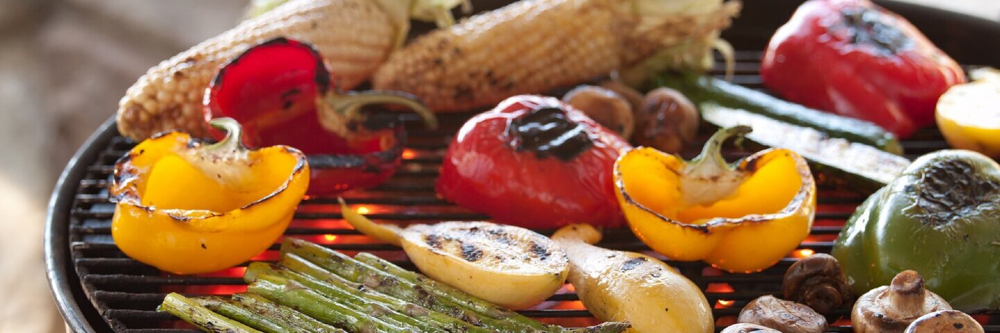 Various grilled vegetables on a barbecue.