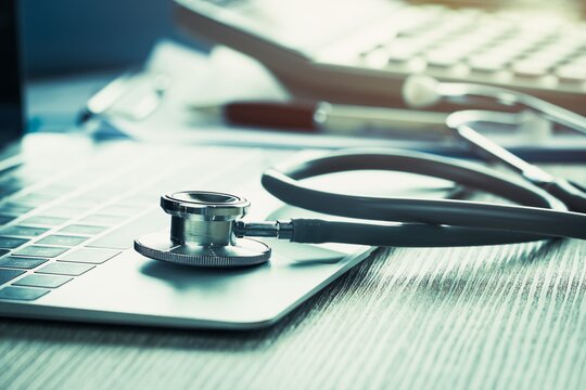 Ein Stethoskop liegt auf einem Laptop.