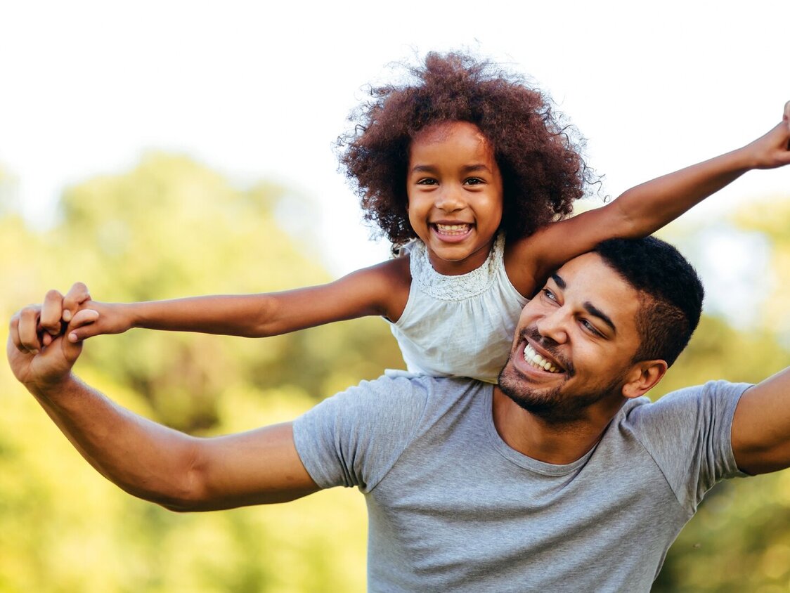 Portrait,Of,Young,Father,Carrying,His,Daughter,On,His,Back
