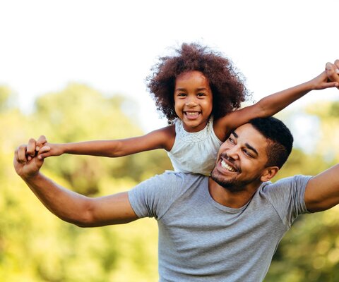 Portrait,Of,Young,Father,Carrying,His,Daughter,On,His,Back