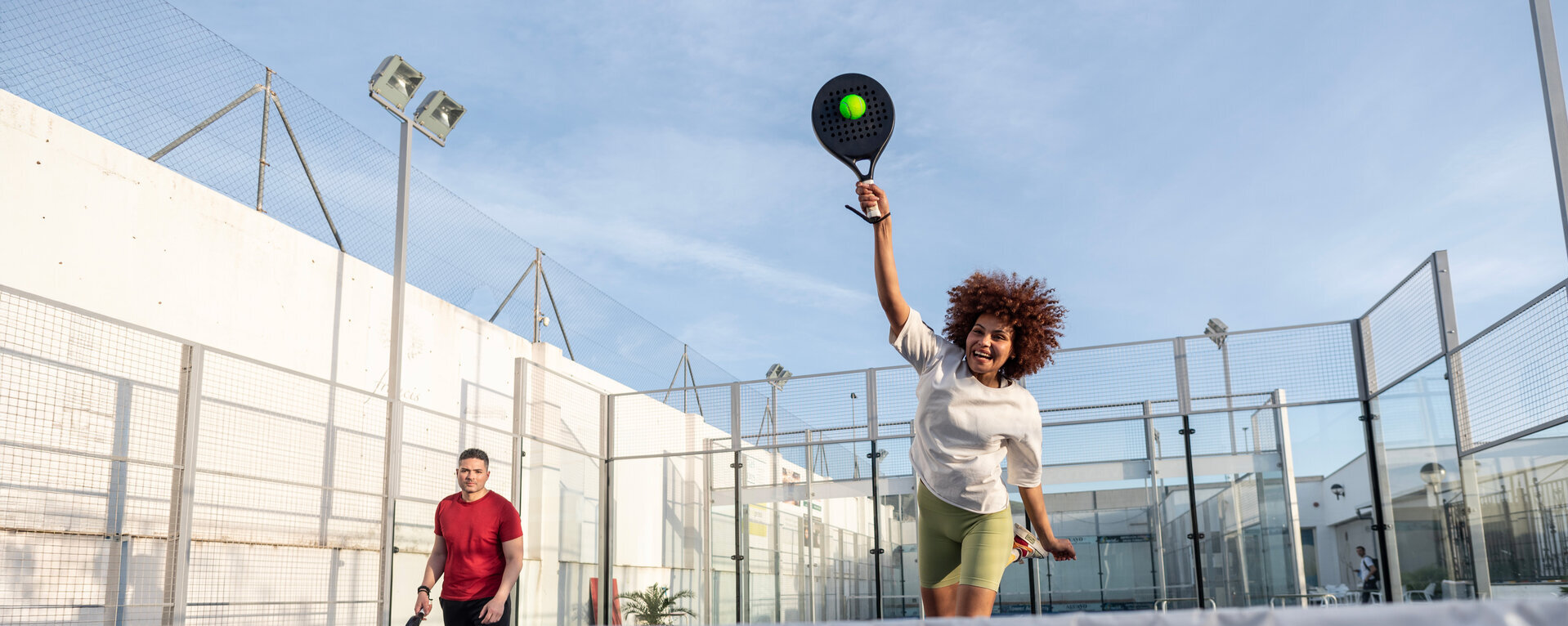 Zwei Personen sind auf einem Padelcourt und spielen Padel