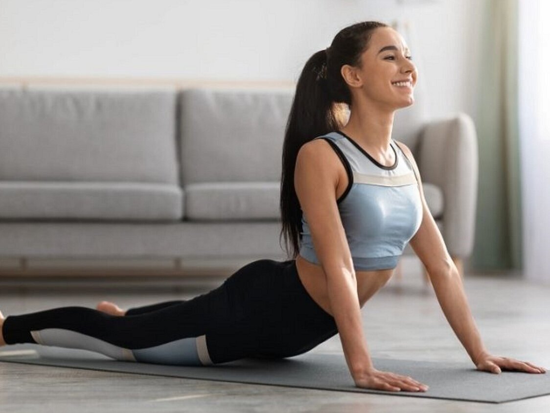 Active,Young,Woman,In,Sportswear,Practicing,Yoga,At,Home,,Laying